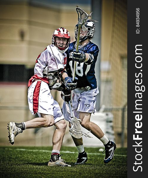 Two American men challenging for the ball in game of lacrosse. Two American men challenging for the ball in game of lacrosse.