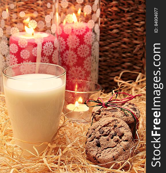 Clear Glass Candle Holder Beside The Brown And Brown Cookie