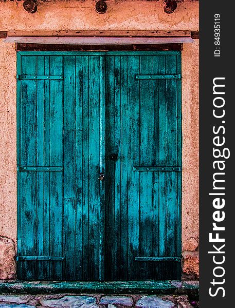 An old blue wooden entrance door. An old blue wooden entrance door.