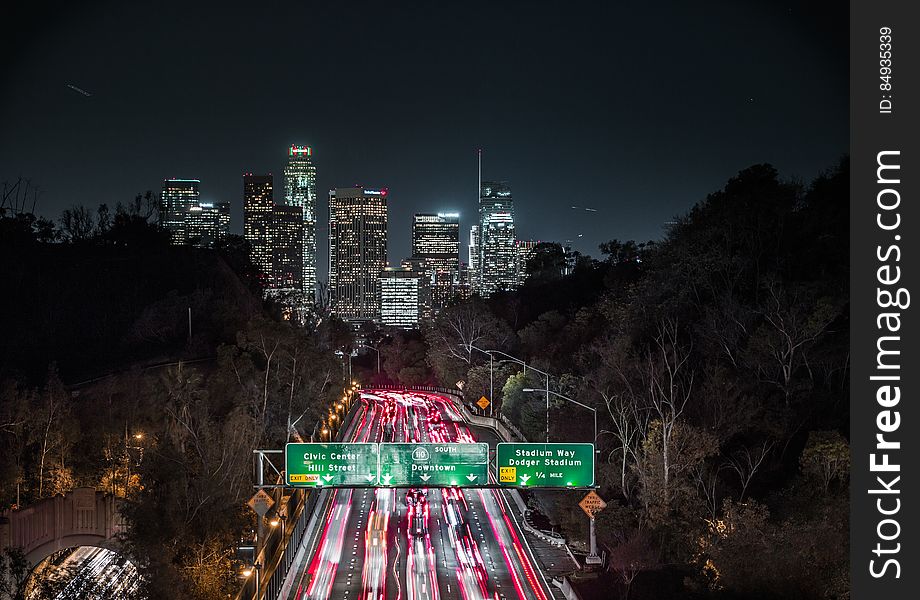 A view of the city of Los Angeles with the interstate 110 full of cars at night. A view of the city of Los Angeles with the interstate 110 full of cars at night.