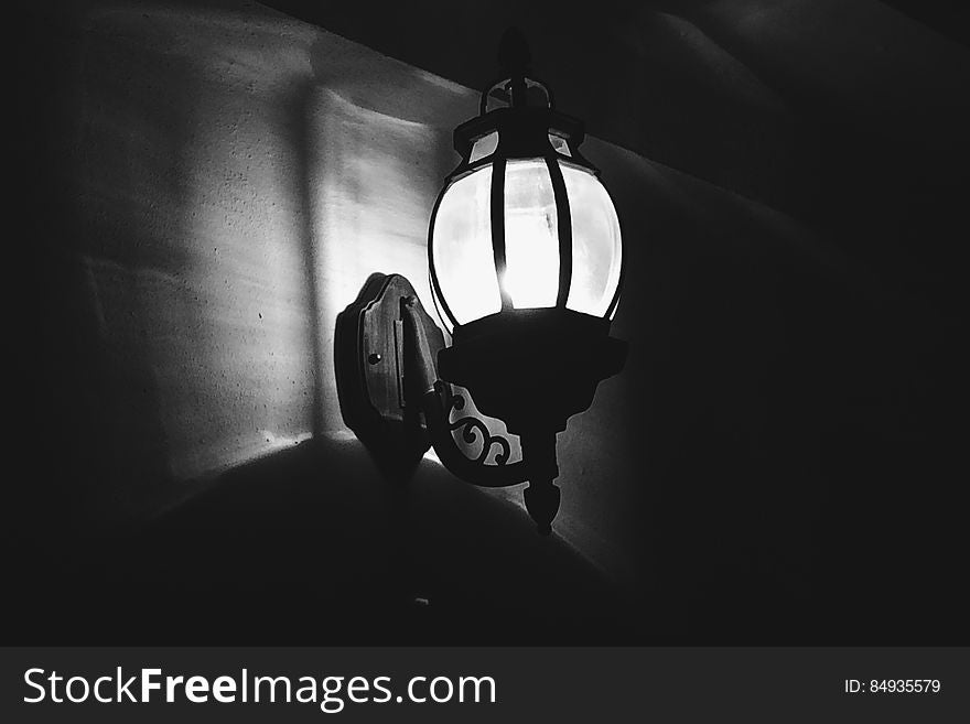 Monochrome view of illuminated vintage style light at night.