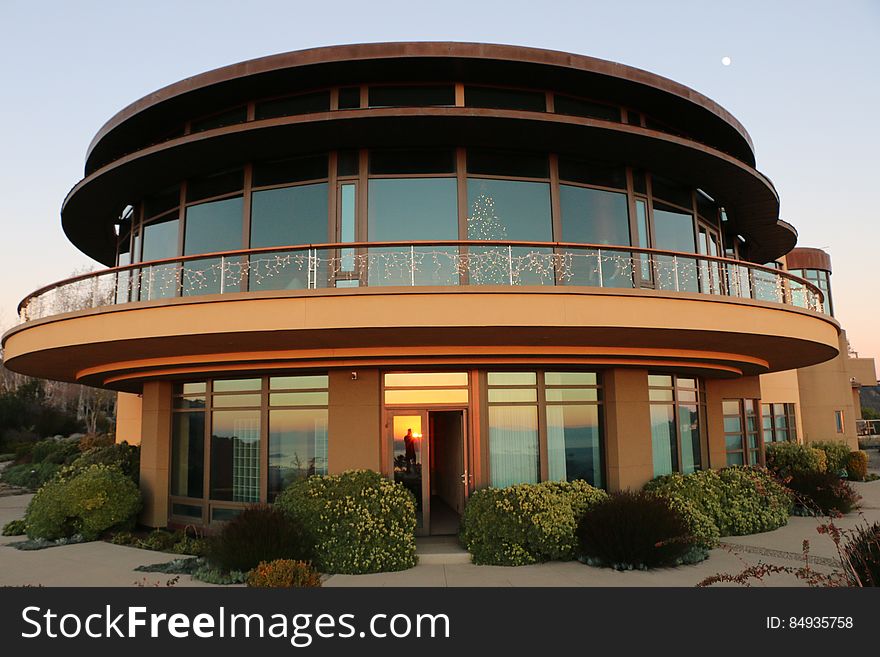 A modern house with round glass walls.