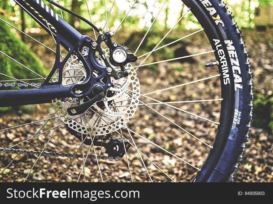 A close up shot of a bicycle back wheel outdoor.