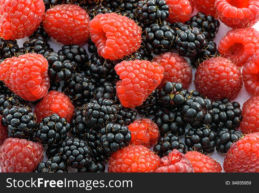 Textured background of fresh fruits created with closeup of Blackberries and Raspberries. Textured background of fresh fruits created with closeup of Blackberries and Raspberries.