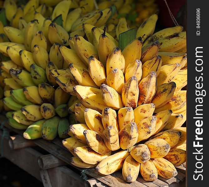 A market stall of ripe bunches of bananas. A market stall of ripe bunches of bananas.