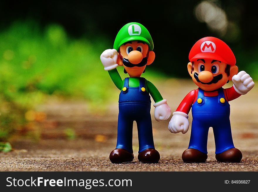 Macro Photography of Mario and Luigi Plastic Toy