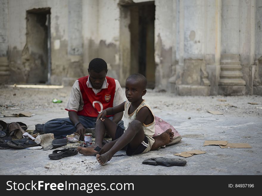 A father and his son repair shoes on the floor of Mogadishu&#x27;s old cathedral, now largely a ruin after two decades of civil war in Somalia. Although much of Mogadishu now lies in ruins, a newfound peace has meant that many of the city&#x27;s residents have been able to return to work and their normal daily lives. 18 November, 2012. AU-UN IST PHOTO / TOBIN JONES. A father and his son repair shoes on the floor of Mogadishu&#x27;s old cathedral, now largely a ruin after two decades of civil war in Somalia. Although much of Mogadishu now lies in ruins, a newfound peace has meant that many of the city&#x27;s residents have been able to return to work and their normal daily lives. 18 November, 2012. AU-UN IST PHOTO / TOBIN JONES.