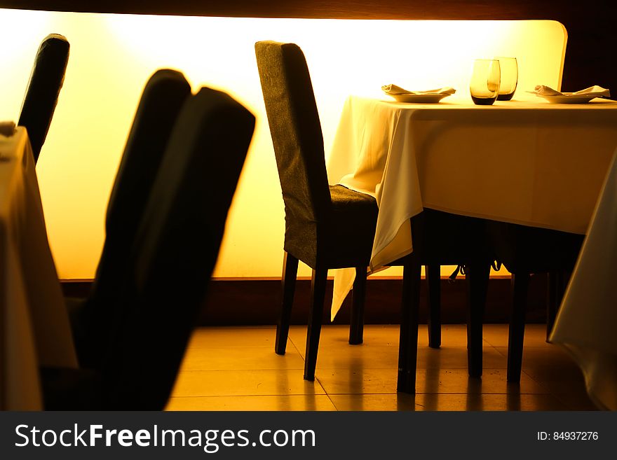 Beige Table Cloth Beside Black Padded Chair