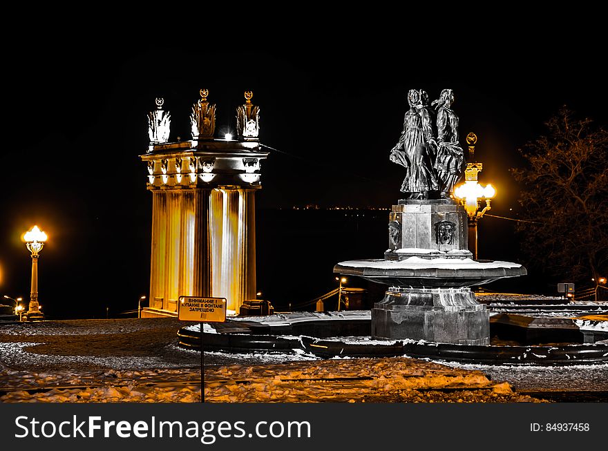A fountain and a monument at night in the winter. A fountain and a monument at night in the winter.