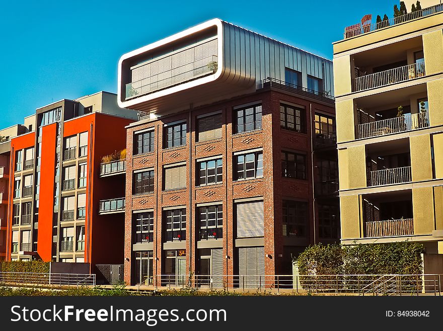 A row of residential buildings with the facades of different color. A row of residential buildings with the facades of different color.