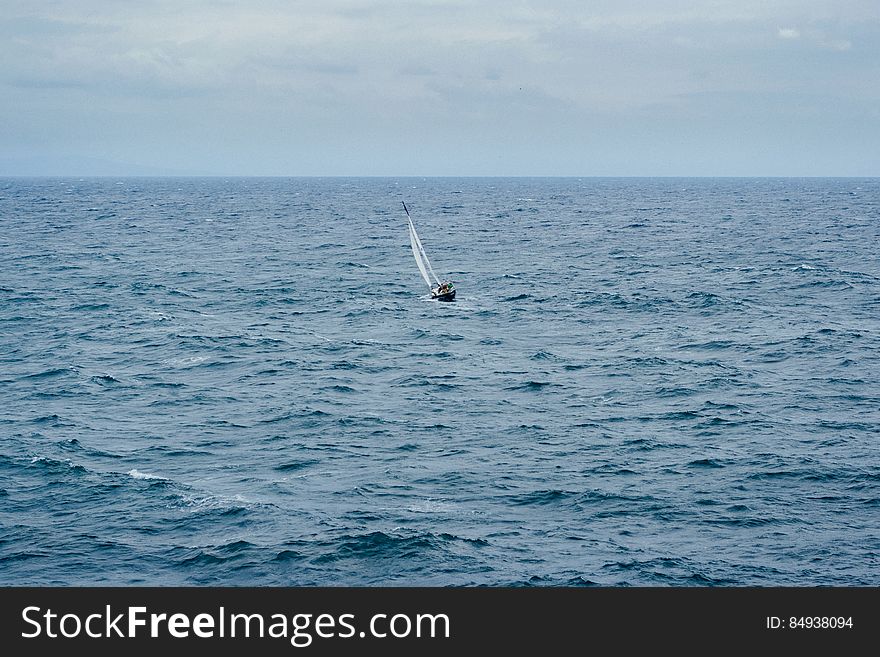 A small sailboat on the sea. A small sailboat on the sea.