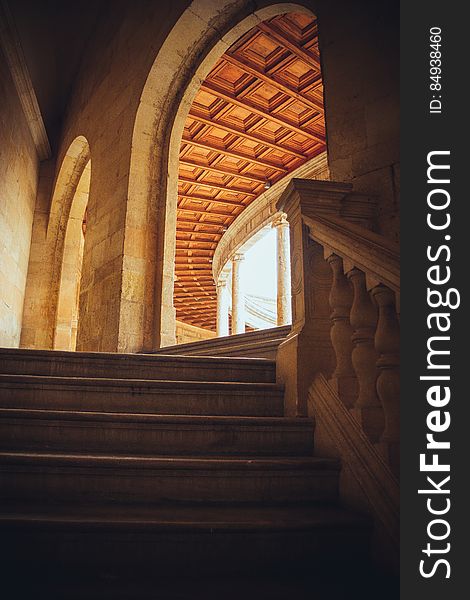 Interior of historic building with wooden steps and arched roof, window in background. Interior of historic building with wooden steps and arched roof, window in background.