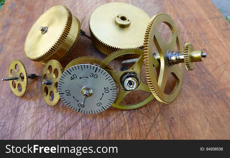 A close up of cogwheels and other pieces of a clock mechanism.