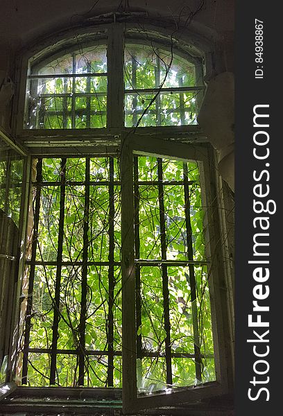 An old window of an abandoned dilapidated house. An old window of an abandoned dilapidated house.