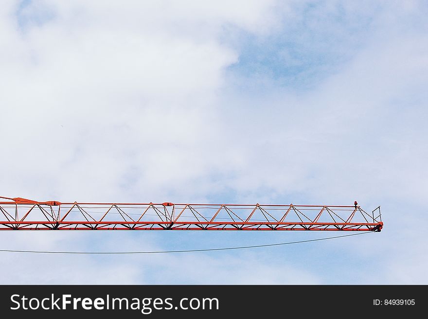 Red Crane Photo Under Cloudy Sky during Daytime