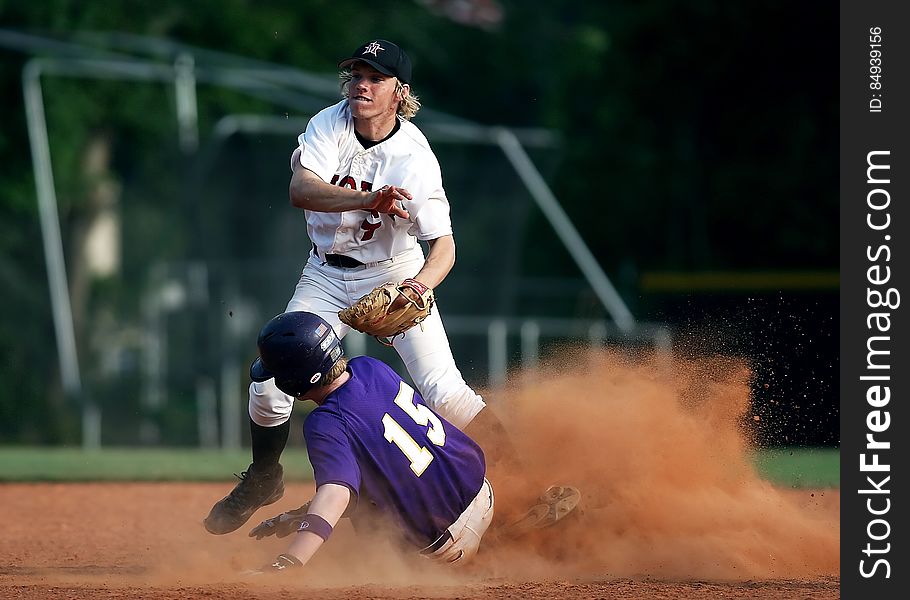 2 Man Playing Baseball on Brown Field