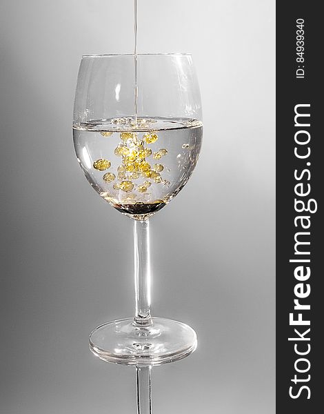 Clear Long Stem Wine Glass With Yellow Liquid