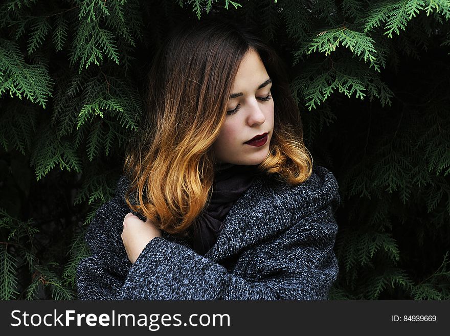 Portrait of Young Woman in Forest during Winter