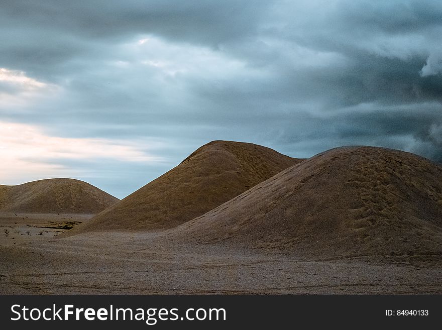 A view across a desert with sand dunes.