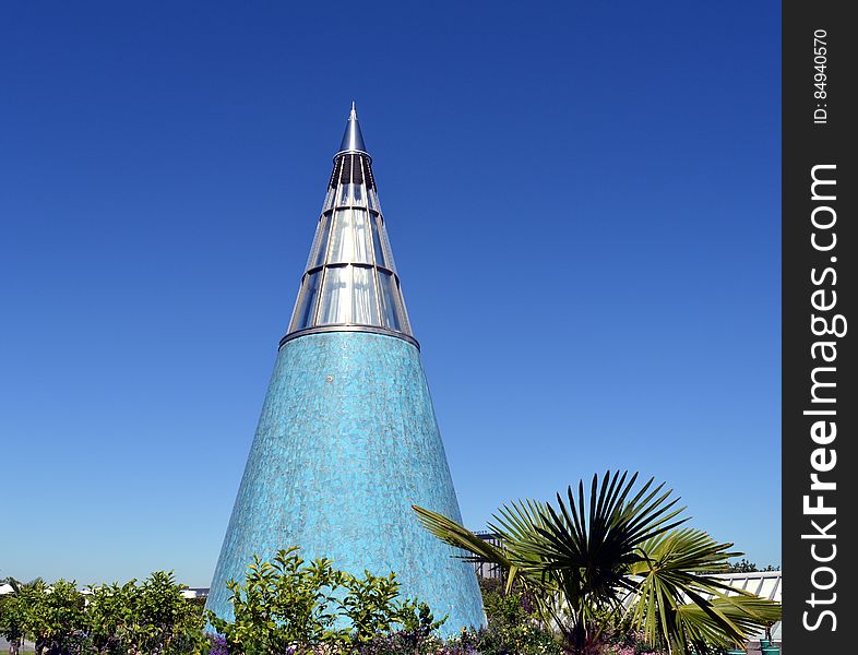 A blue conical building with a metallic tip. A blue conical building with a metallic tip.