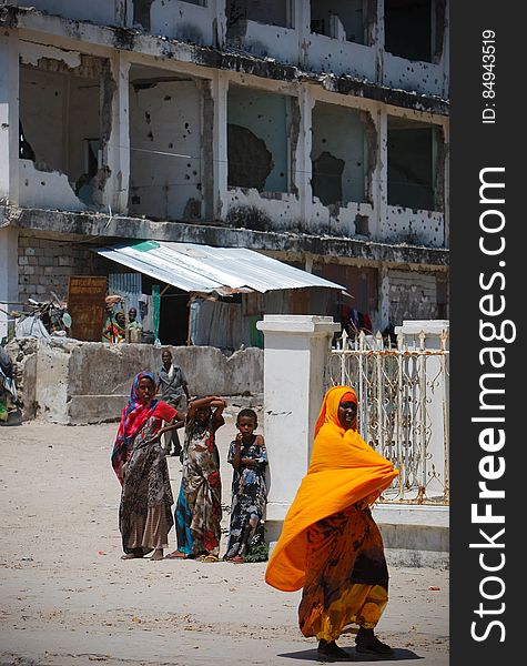 A woman walks past Somali children standing in front of a derelict building in the Abdul-Aziz district of the Somali capital Mogadishu 09 November 2012. The United Nations Security Council on November 7 renewed the mandate of the African Union Mission in Somalia &#x28;AMISOM&#x29; peacekeeping force for a further four months to continue providing support to the Government of Somalia in its efforts to bring peace and stability to the Horn of African country. AU-UN IST PHOTO / STUART PRICE. A woman walks past Somali children standing in front of a derelict building in the Abdul-Aziz district of the Somali capital Mogadishu 09 November 2012. The United Nations Security Council on November 7 renewed the mandate of the African Union Mission in Somalia &#x28;AMISOM&#x29; peacekeeping force for a further four months to continue providing support to the Government of Somalia in its efforts to bring peace and stability to the Horn of African country. AU-UN IST PHOTO / STUART PRICE.