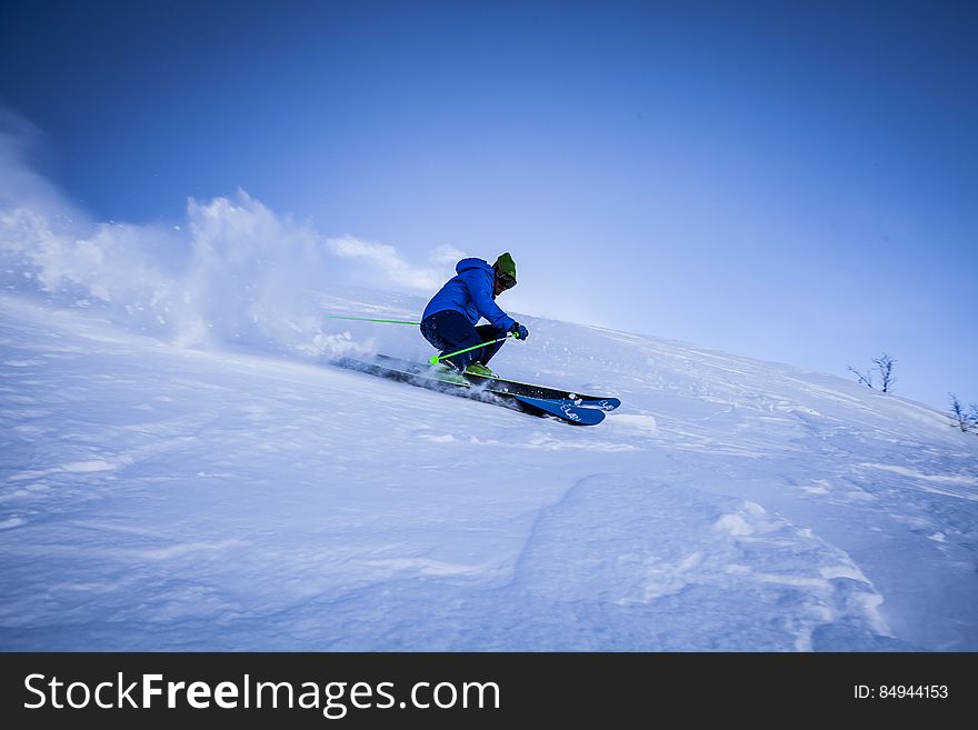 A skier on a slope with deep snow. A skier on a slope with deep snow.