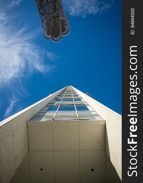 A low angle view of a high rise building against the blue sky. A low angle view of a high rise building against the blue sky.