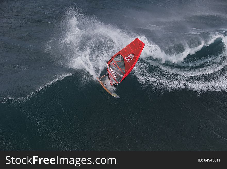 Person in Surfboard in the Wave during Daytime