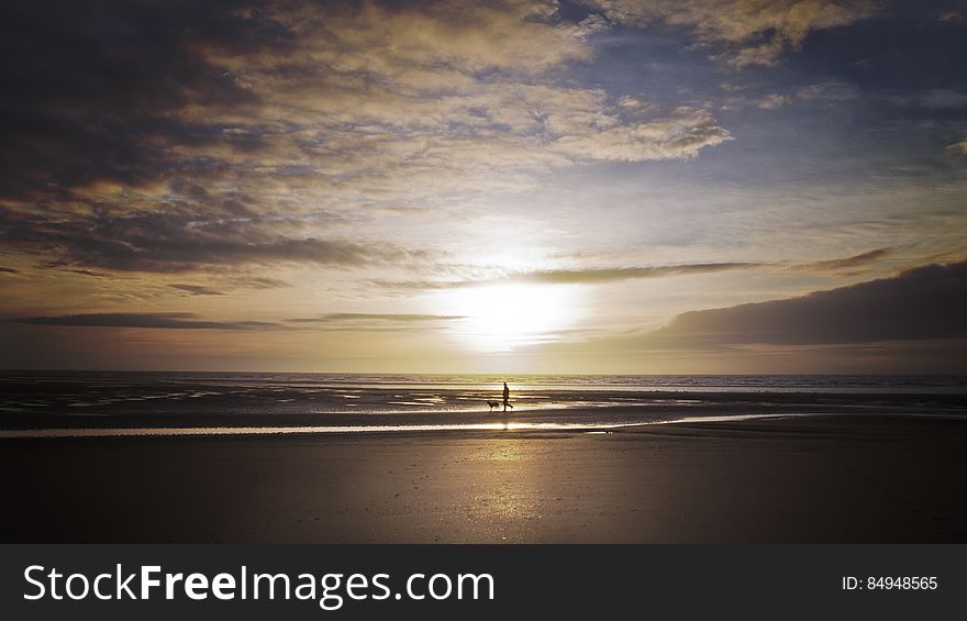 Here is a photograph I took of a man walking the dog during a sunset on Cleveleys Beach.