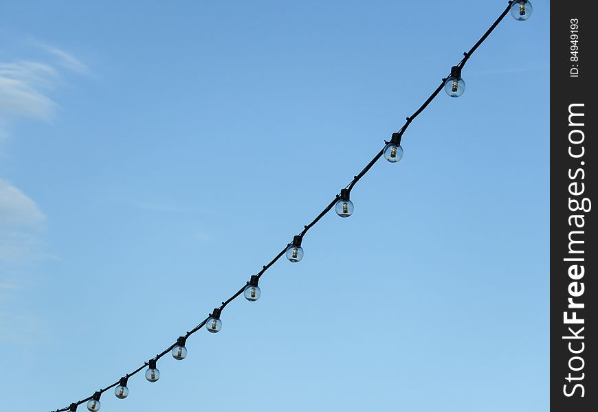 String Of Lights With Blue Sky In Background