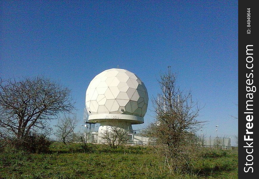 A geodesic dome under blue skies.