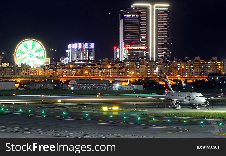 A city on the background of an airport in the night. A city on the background of an airport in the night.