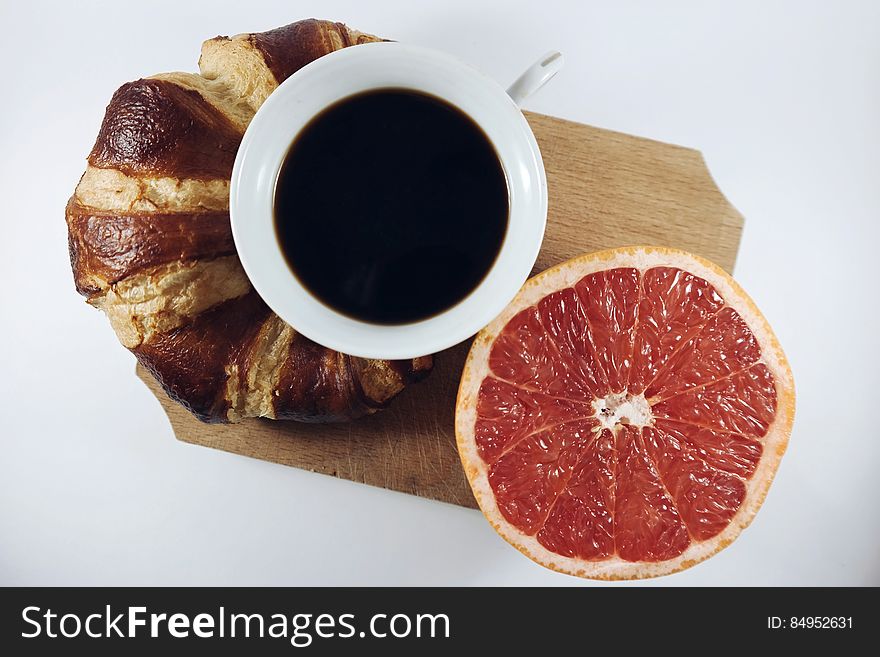 Croissant coffee and grapefruit