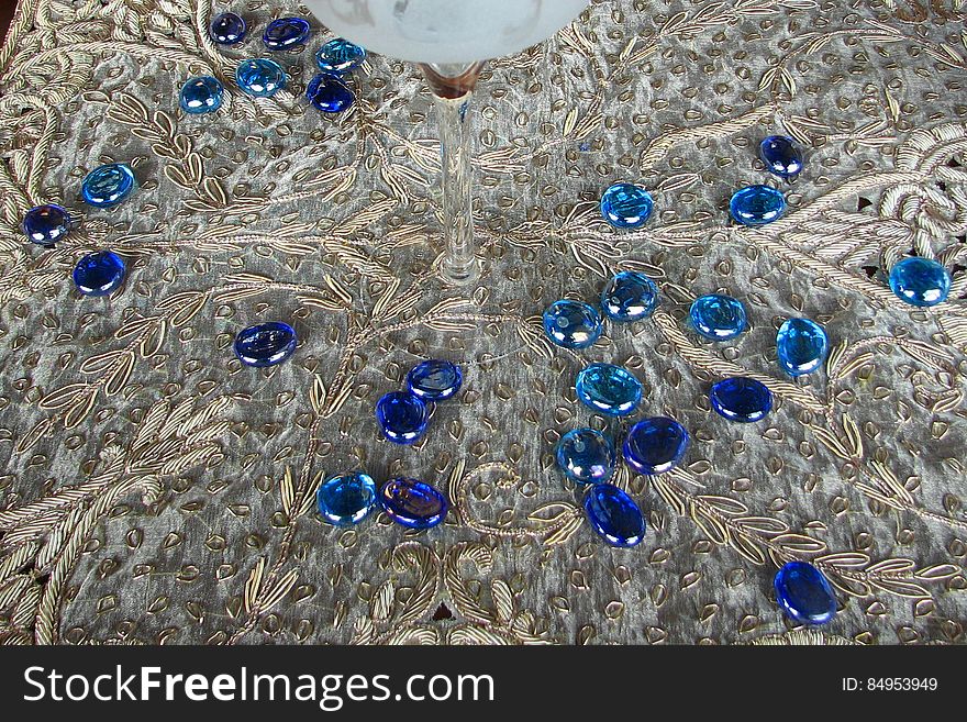 blue glass pebbles on lace