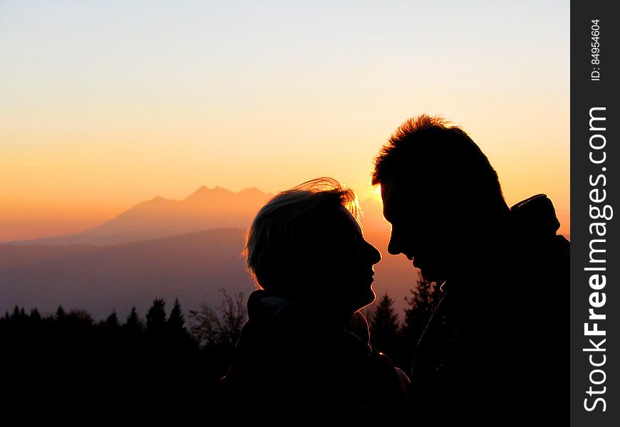 Silhouette Couple Kissing Against Sky during Sunset