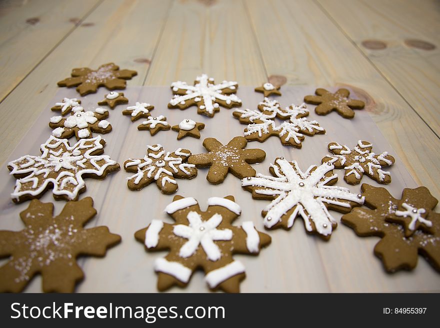 Gingerbread snowflake cookies on a wooden background.