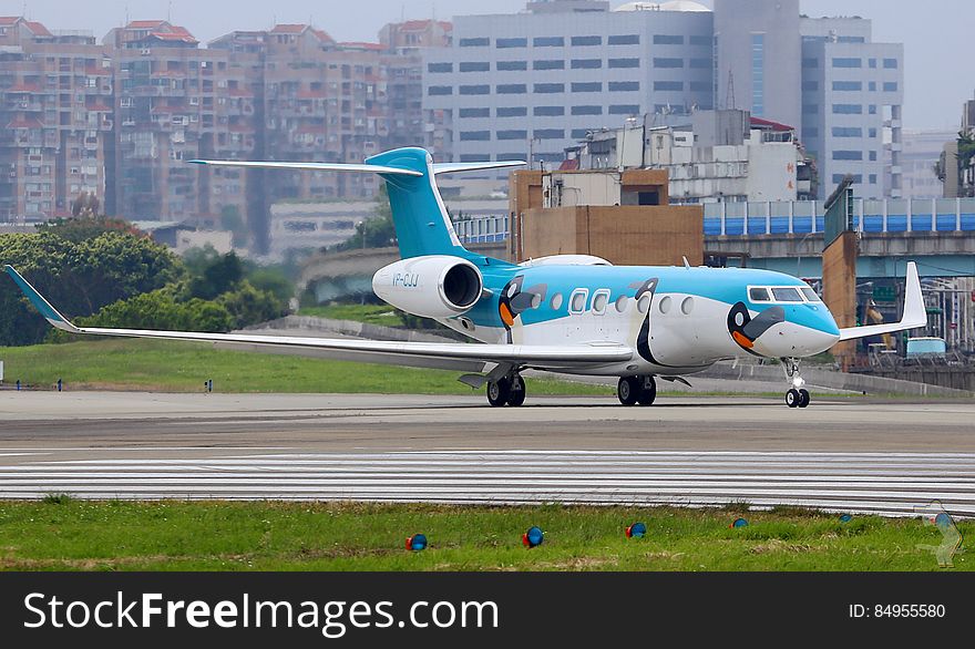 Commercial jet on runway in urban airport.