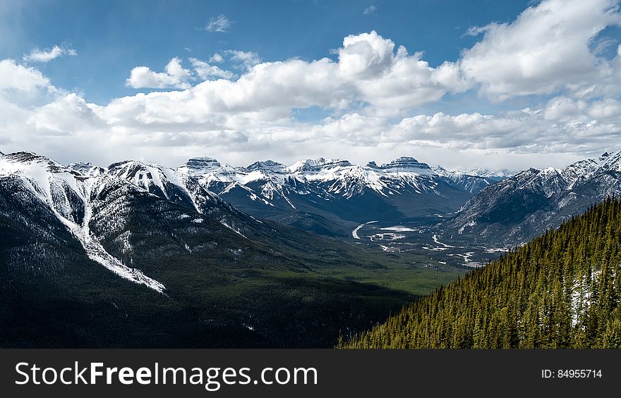 A valley lined with snow capped mountains. A valley lined with snow capped mountains.