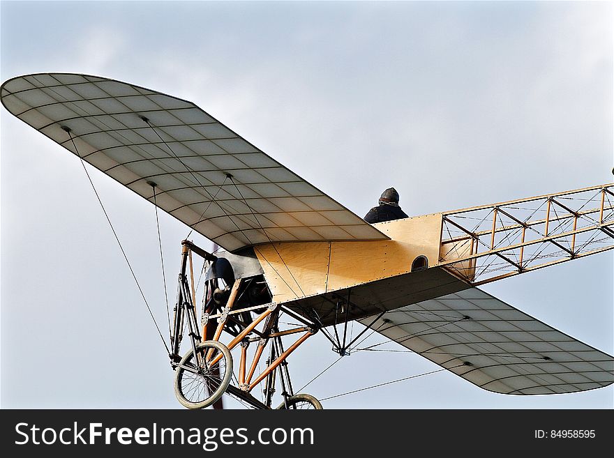 An vintage French Bleriot airplane flying on the sky.