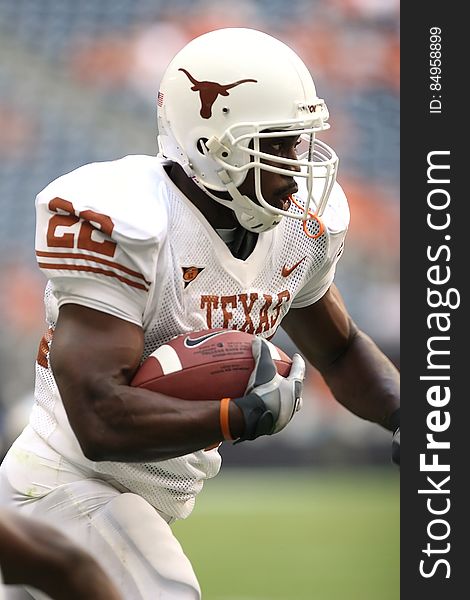 Man Wearing Texas Nike 22 Jersey Holding Ball and Running during Daytime