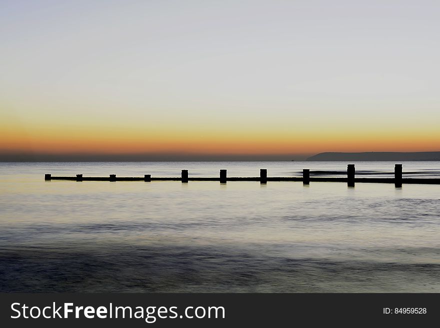 Scenic View of Sea Against Clear Sky during Sunset