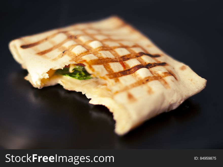 A square wrapped tortilla fried on griddle. A square wrapped tortilla fried on griddle.