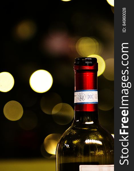 A bottle of wine with blurred bokeh background.