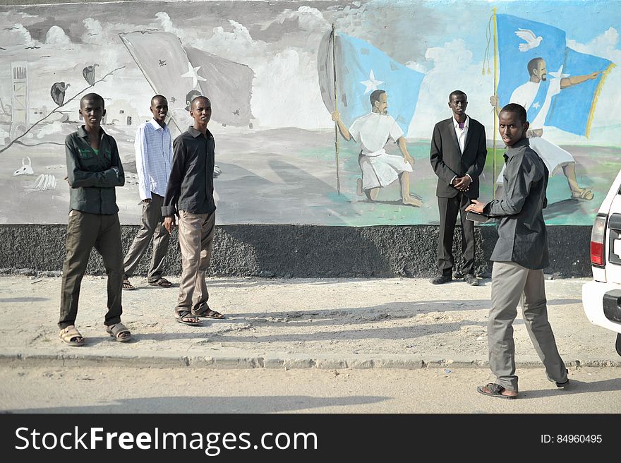 A group of young men take their picture against a mural next to the Tomb of the Unknown Soldier in Mogadishu, Somalia, on July 28. AMISOM Photo / Tobin Jones. A group of young men take their picture against a mural next to the Tomb of the Unknown Soldier in Mogadishu, Somalia, on July 28. AMISOM Photo / Tobin Jones