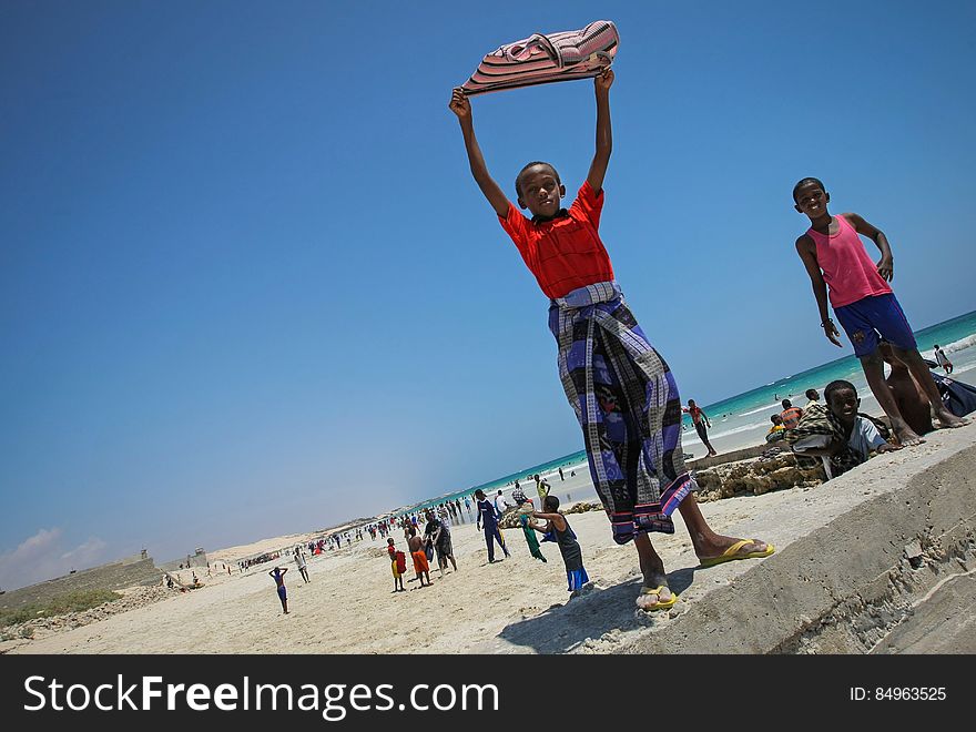 A Somali boy holds a shirt aloft to dry in the wind at Lido Beach in the Abdul-Aziz district of the Somali capital Mogadishu 09 November 2012. Lido Beach has become a popular spot on Friday&#x27;s with hundreds of Somalis since the withdrawal in August 2011 of the Al-Qaeda affiliated extremist group Al Shabaab who had banned any such social gatherings between men and women. The United Nations Security Council on November 7 renewed the mandate of the African Union Mission in Somalia &#x28;AMISOM&#x29; peacekeeping force for a further four months to continue providing support to the Government of Somalia in its efforts to bring peace and stability to the Horn of African country. AU-UN IST PHOTO / STUART PRICE. A Somali boy holds a shirt aloft to dry in the wind at Lido Beach in the Abdul-Aziz district of the Somali capital Mogadishu 09 November 2012. Lido Beach has become a popular spot on Friday&#x27;s with hundreds of Somalis since the withdrawal in August 2011 of the Al-Qaeda affiliated extremist group Al Shabaab who had banned any such social gatherings between men and women. The United Nations Security Council on November 7 renewed the mandate of the African Union Mission in Somalia &#x28;AMISOM&#x29; peacekeeping force for a further four months to continue providing support to the Government of Somalia in its efforts to bring peace and stability to the Horn of African country. AU-UN IST PHOTO / STUART PRICE.