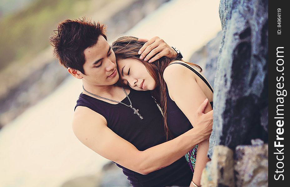 Man Hugging A Woman Wearing Black Tank Top