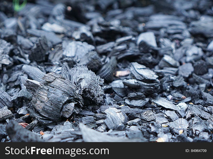 A background of pieces of charcoal.