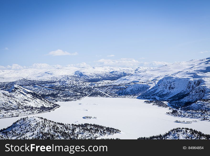 A panoramic view of a mountain valley covered in snow. A panoramic view of a mountain valley covered in snow.