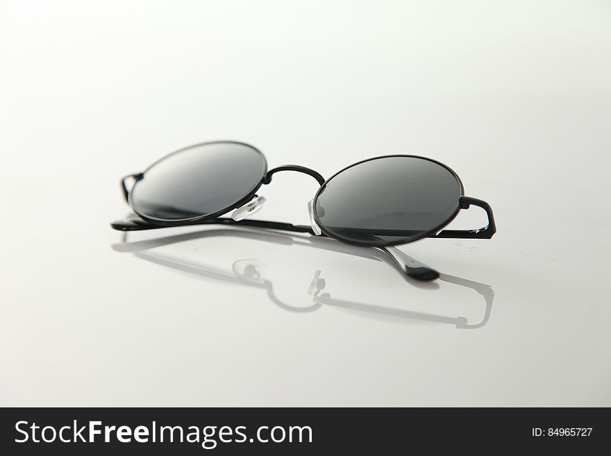 Black Frame Sunglasses On White Surface