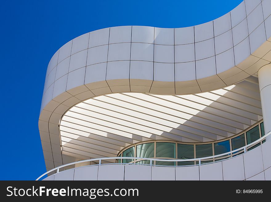 A close up of a building with curved wall and balcony. A close up of a building with curved wall and balcony.